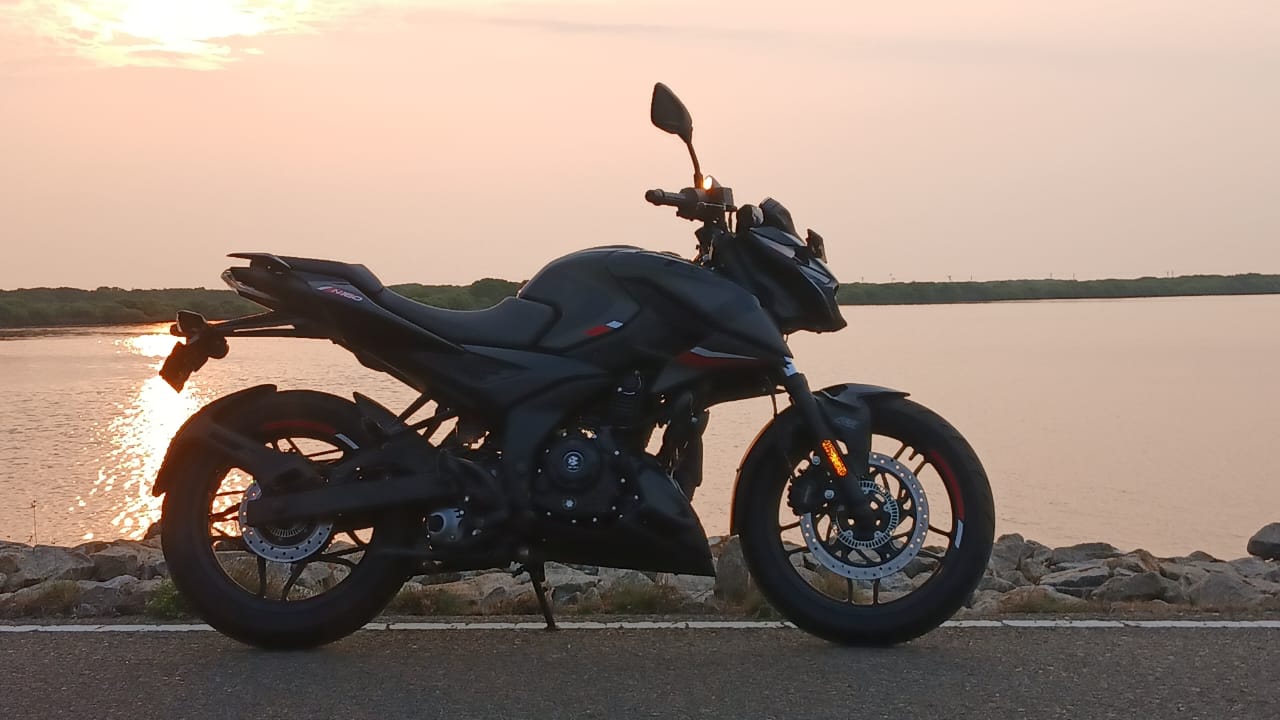 Motorcycle parked overlooking tropical mountains